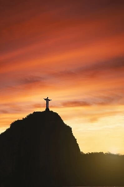 Statue of Christ the Redeemer at sunset, Corcovado, Rio de Janeiro, Brazil, South America