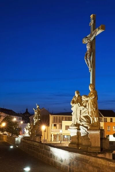 Statue of Crucified Jesus Christ on Kamenny Most, the oldest Gothic stone bridge in Czech Republic, at dusk, Pisek, Budejovicko, Czech Republic, Europe