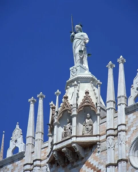Statue on top of the Doges Palace in St. Marks Square in Venice, UNESCO World Heritage Site