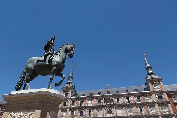 Statue of Felipe III and the painted Casa de la Panaderia in the Plaza Mayor in Madrid