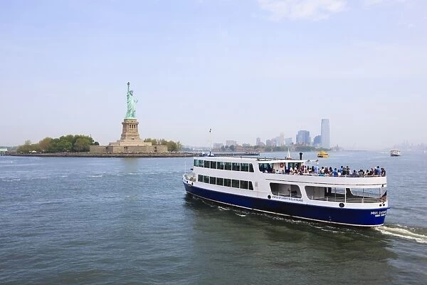 The Statue of Liberty and ferry, Liberty Island, New York City, New York