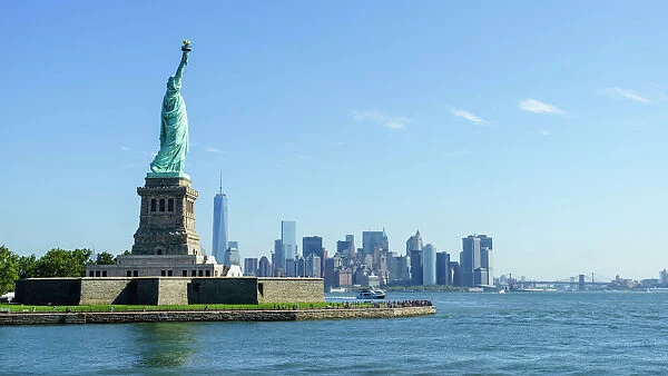 Statue of Liberty and Liberty Island with Manhattan skyline in view, New York City, New York, United States of America, North America