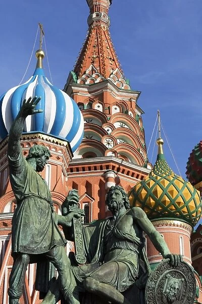 Statue of Minin and Pozharskiy and the onion domes of St. Basils Cathedral in Red Square, UNESCO World Heritage Site, Moscow, Russia, Europe