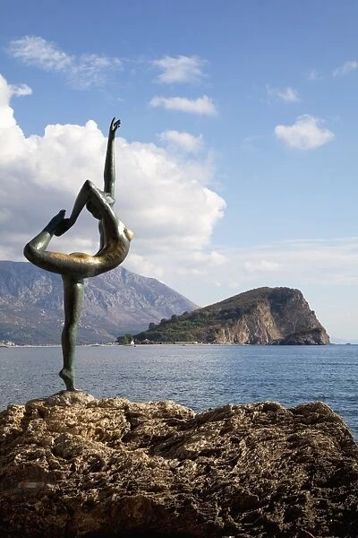 Statue of naked dancing girl on a rock near the Adriatic with Sveti Nikola island in the background
