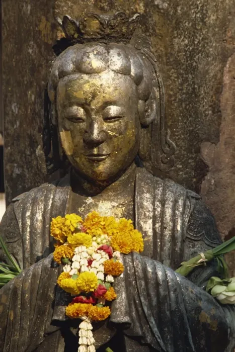 Framed Print : Detail of statue with offering of marigold flowers Framed Print : Detail of statue with offering of marigold flowers