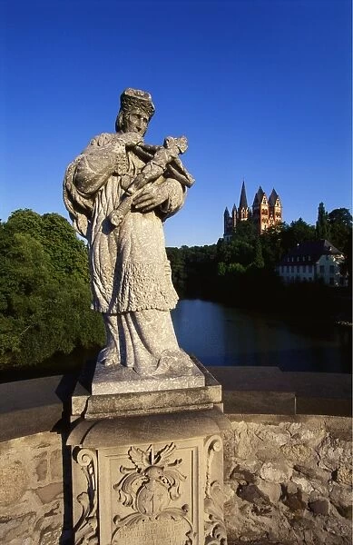 Statue on the Old Lahn-Bridge and a Cathedral in Limburg, Germany