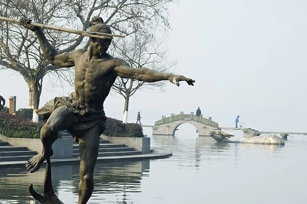 Statue of a spear fisherman in the waters of West Lake, Hangzhou, Zhejiang Province