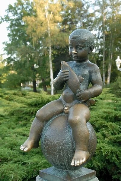 Statue of well-known boy holding a fish at spa Park of Solni and Lucni Spring in the spa town of Frantiskovy Lazne, Karlovarsky Region, West Bohemia, Czech
