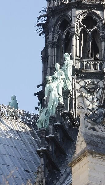 Statues of three apostles at the foot of Notre-Dame-De-Paris cathedral spire