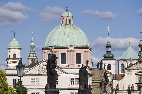 Statues on Charles Bridge and dome of the Church of St. Francis, Old Town