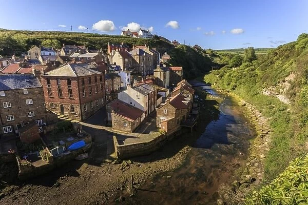 Steep streets of fishing village nd river, elevated view in summer, Staithes, North