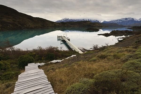 Steps to boatdock and reflections in Lago Pehoe, Torres del Paine National Park, Patagonia, Chile, South America