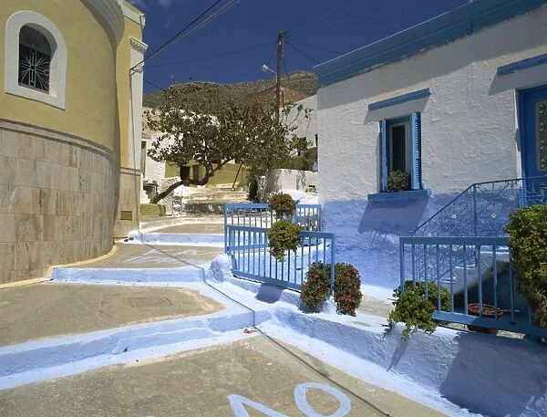 Steps in village street passing blue and white painted house on Kalimnos