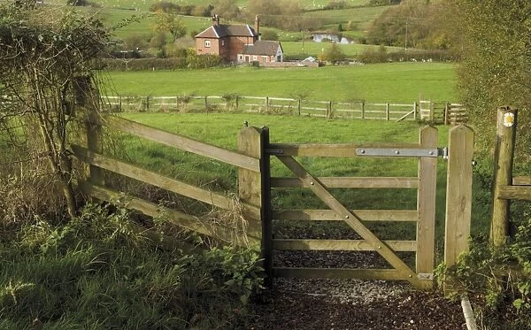 Stile and footpath with lock keepers house beyond, on the Worcester and Birmingham canal