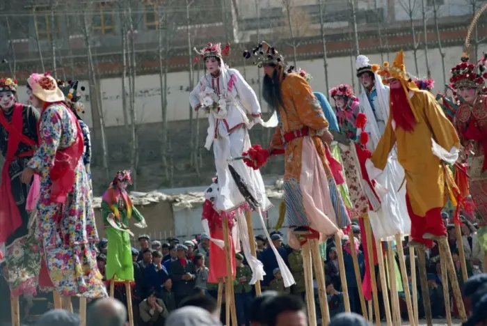 Framed Print : Stilt dancers in parade at New Year celebrations in Qinghai Province, China, Asia Framed Print : Stilt dancers in parade at New Year celebrations in Qinghai Province, China, Asia