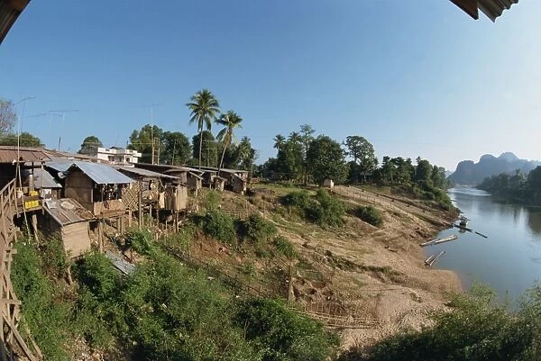 Stilt houses along the bank of the Xe Beng Fai River