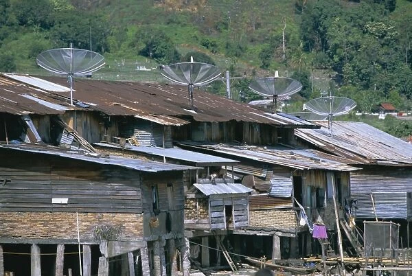 Stilt houses with satellite dishes
