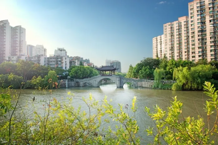 Framed Print : Stone bridge with pagoda style roofing, flanked by old style apartment buildings on the left Framed Print : Stone bridge with pagoda style roofing, flanked by old style apartment buildings on the left