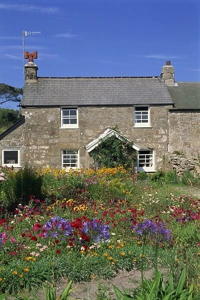 Stone cottage and colourful garden at New Grimsby on Tresco in the Scilly Isles