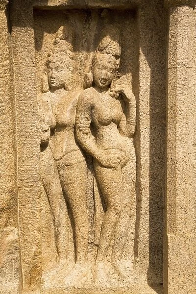 The stone figures of two women within the Five Rathas (Panch Rathas) complex at Mahabalipuram