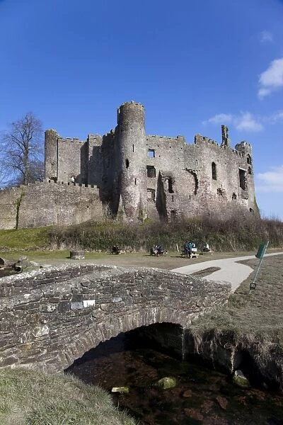Stone footbridge in front of Laugharne Castle, Carmarthenshire, Wales, United Kingdom