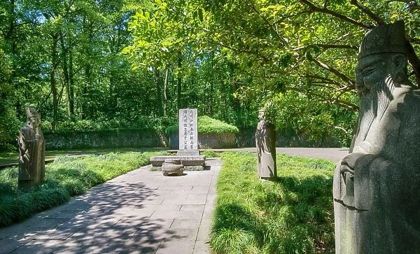 Stone statues watching over an old tomb in the gardens of Hangzhou, Zhejiang, China, Asia