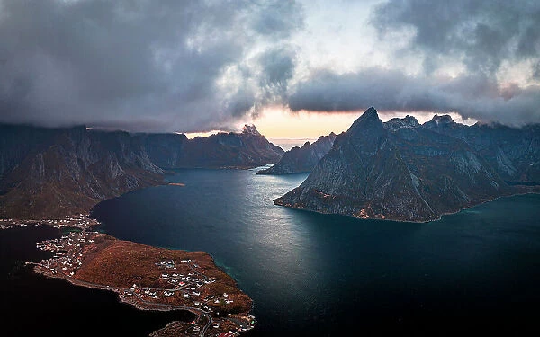 Storm clouds at sunset over majestic mountains along a fjord, aerial view, Reine Bay, Lofoten Islands, Nordland, Norway, Scandinavia, Europe
