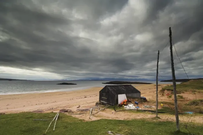 Framed Print : Stormy sky with fishermans hut and net drying poles, Redpoint beach Framed Print : Stormy sky with fishermans hut and net drying poles, Redpoint beach
