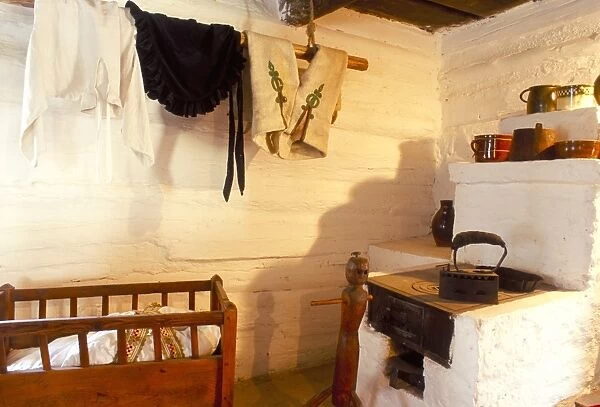 Stove and cot in living room of traditional house