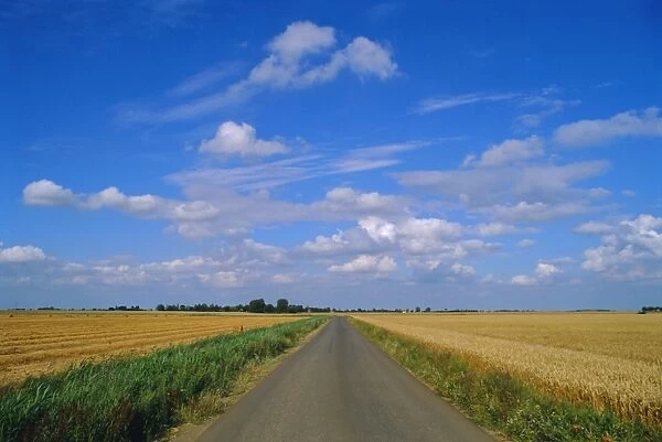 Straight country road through fenland near Peterborough, Cambridgeshire, England, UK