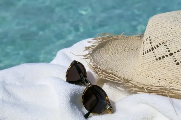 Framed Print : Straw hat and sunglasses on towel Framed Print : Straw hat and sunglasses on towel