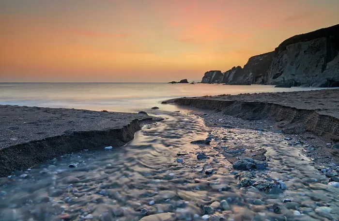 Framed Print : A stream cuts across sand as it reaches the sea, at dusk, in Ayrmer Cove, a remote cove near Kingsbridge, south coast of Devon, England, United Kingdom, Europe Framed Print : A stream cuts across sand as it reaches the sea, at dusk, in Ayrmer Cove, a remote cove near Kingsbridge, south coast of Devon, England, United Kingdom, Europe