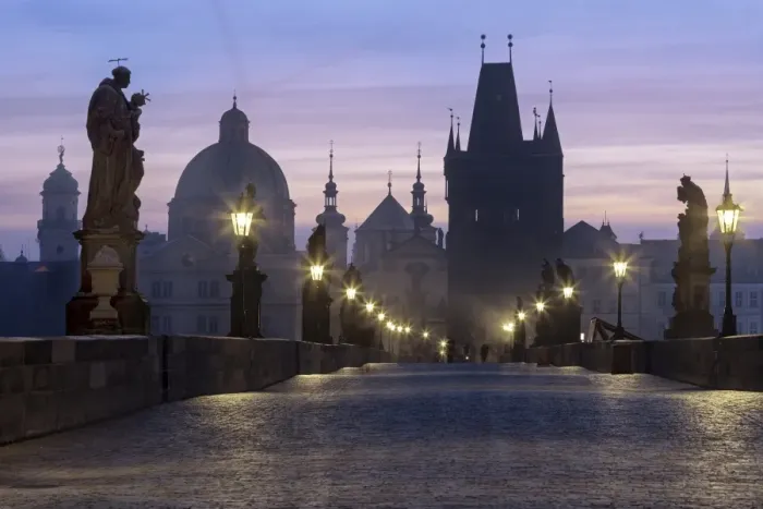 Framed Print : Street lanterns and old statues frame the historical buildings on Charles Bridge at dawn Framed Print : Street lanterns and old statues frame the historical buildings on Charles Bridge at dawn