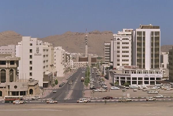 Street with modern buildings and telecommunications tower in Ruwi
