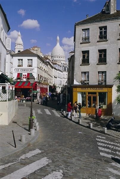 Street scene and the dome of the basilica of Sacre Coeur, Montmartre, Paris