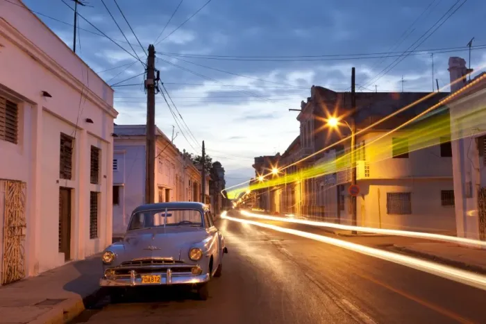 Framed Print : Street scene at night showing Classic American car and the light trails of passing traffic Framed Print : Street scene at night showing Classic American car and the light trails of passing traffic