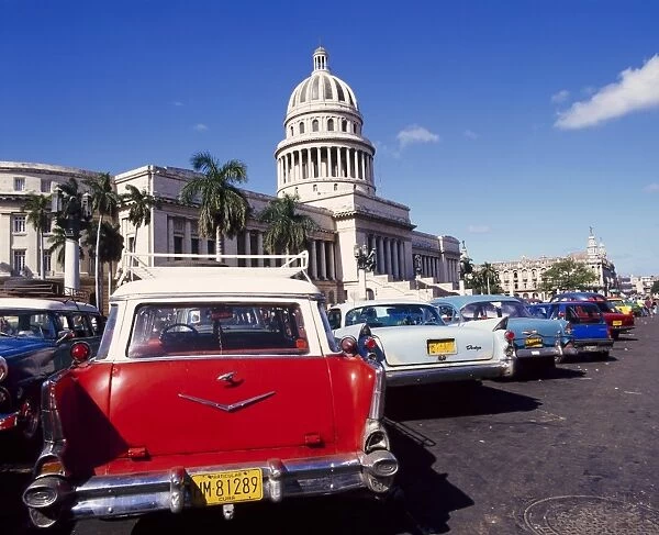 Street scene of taxis parked near the Capitolio Building in Central Havana