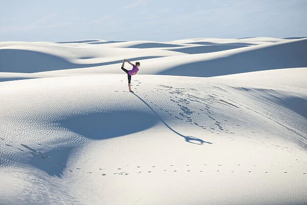 Stretching with a yoga pose in White Sands National Park, New Mexico
