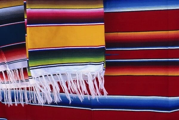 Striped woven rugs in vibrant primary colours for sale in Mexico