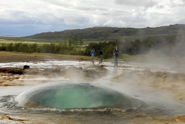 Strokkur, the unique dome of water that rises at the start of each powerful eruption of the geyser that erupts every 10 minutes, beside the now-inactive Geysir, southeast Iceland, Iceland