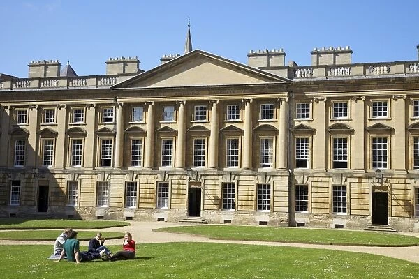 Students sitting outside in spring sunshine, Peckwater Quadrangle, designed by Henry Aldrich