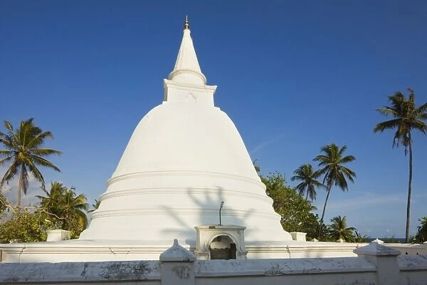 Stupa (dagoba) at a small Buddhist temple overlooking the south coast at Mirissa, near Matara, Southern Province, Sri Lanka, Asia