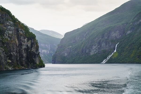 The Suitor Waterfall lies directly opposite the Seven Sisters Waterfall, Geirangerfjord