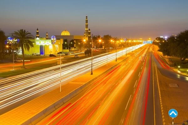 Sultan Qaboos Grand Mosque and traffic on Sultan Qaboos Street at sunset, Muscat