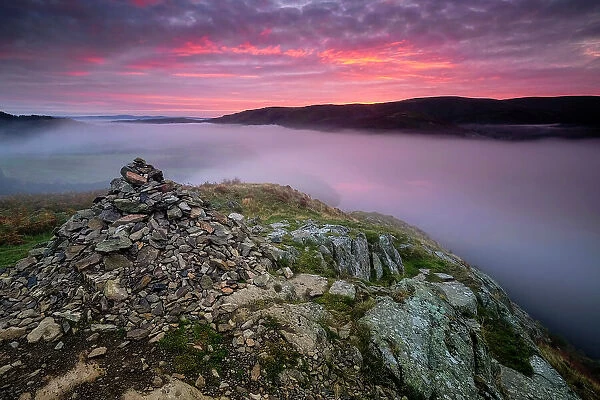 Summit Cairn on Yew Crag above misty Ullswater at sunrise, Gowbarrow Fell, Lake District National Park, UNESCO World Heritage Site, Cumbria, England, United Kingdom, Europe