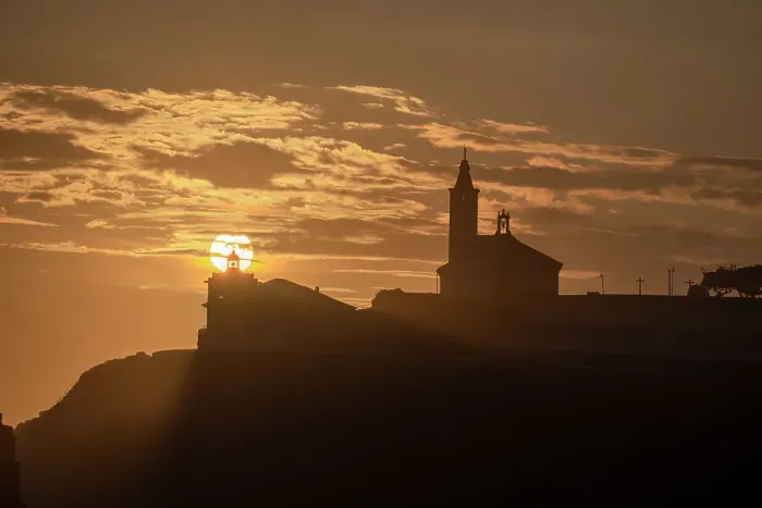 Framed Print : Sun aligned with the silhouette of the lighthouse and church of Luarca, Asturias, Spain, Europe Framed Print : Sun aligned with the silhouette of the lighthouse and church of Luarca, Asturias, Spain, Europe