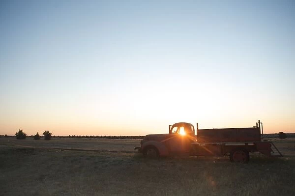 The sun beams through window of old farm truck at sunrise, Shaniko, California, United States of America, North America