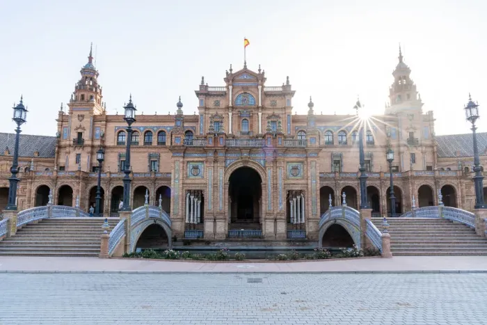 Framed Print : A sun burst as it rises over the central building of Plaza de Espana Framed Print : A sun burst as it rises over the central building of Plaza de Espana