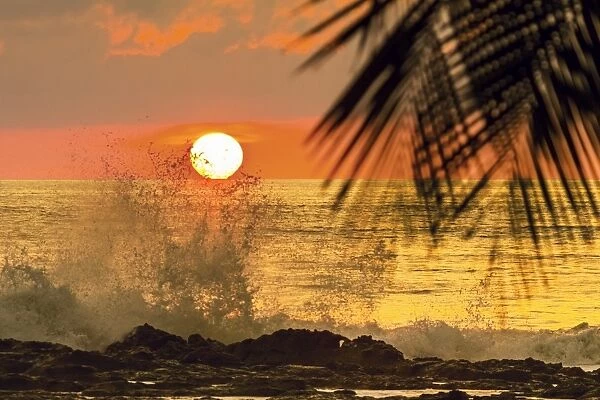 Sun going down behind surf spray at this resort near Mal Pais, southern Nicoya Peninsula