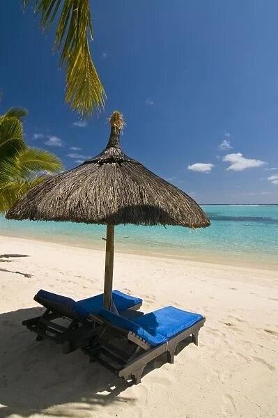 Sun lounger on the beach of the Beachcomber Le Paradis five star hotel